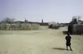 A boy in front of three mosques of Bani in the distance, 1983