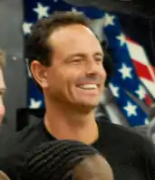 A smiling man with close-cropped dark hair