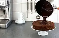 Ganache being poured atop a cake