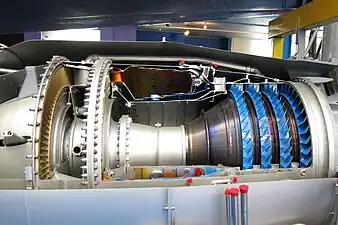 Rolls-Royce Turbomeca Adour military turbofan. There is a requirement to maintain a certain minimum pressure-loss in  combustors, rather than reducing it as much as possible to minimize entropy production. It has to be maintained to prevent backflow in the turbine cooling circuits since cooling air from the HP compressor needs a lower pressure at the turbines in order to flow. Cooling air from the compressor (blue) has to flow to the turbine area (nozzle guide vane painted orange). This is enabled by the drop in pressure which occurs in the combustor. Also evident is the increase in area from the compressor into the combustor which is necessary to slow the air.