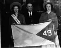 Dorothy Fellows, Miss Absaroka&nbsp;(left), A. R. Swickard (middle), and Esther Aspaas (right), holding the proposed Absaroka state flag.