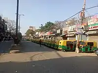 Auto rickshaw stranded in front of closed shops in Delhi