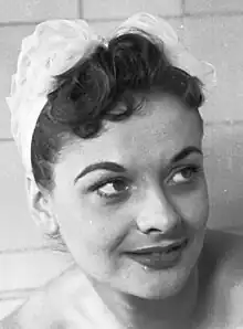 A 23-year-old woman with brown hair smiling to the right.