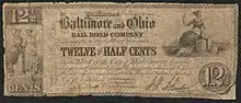 Note inscribed No. 121 Baltimore February 10, 1841 Baltimore and Ohio RAILROAD COMPANY. Transfer to the holder of this order TWELVE AND A HALF CENTS in the Stock of the City of Baltimore bearing Six per cent interest payable quarterly when said holder presents orders amounting to One Hundred Dollars or upwards. [Commissioners holding the Stock to redeem these orders]." The note is illustrated with an illustration of two standing women on the left, and one sitting woman on the right.