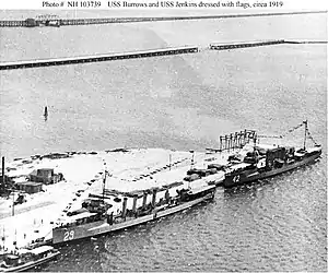 USS Burrows (DD-29) and USS Jenkins (DD-42) in port, dressed with flags, circa 1919.