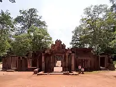 Mur d'entrée d'environ 20 m de large ouvrant sur l'allée centrale.