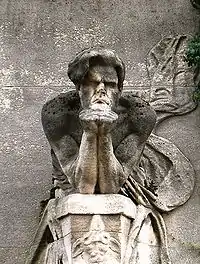 sculpure du torse d'un être humain penché en avant le menton appuyé sur ses poings