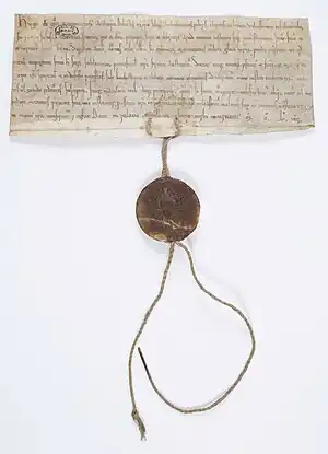 Charte par laquelle Hugues, archevêque de Rouen, accorde à la demande de l'abbé de Saint-Denis, Eudes, la protection de l'Église à ceux qui fréquenteront le marché établi par le roi à Château-sur-Epte. 1154.