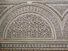 Gros plan sur un décor en plâtre sculpté du patio principal.