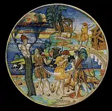 Trois scènes du mythe de Cyparisse sur un émaux à lustre métallique du XVIe&nbsp;siècle par Giorgio Andreoli ; le dieu qui embrasse le jeune qui se transforme tient une branche dans sa main.