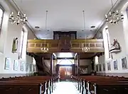 Vue intérieure de la nef vers la tribune de l'orgue Koulen (1887).