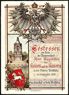 Première page du menu pour le banquet en l'honneur de la présence de Guillaume II (empereur allemand) et de Augusta-Victoria de Schleswig-Holstein-Sonderbourg-Augustenbourg à l'Hotel Kaiserhof (Porta Westfalica)&nbsp;(de) le 7 septembre 1898. Taille : 26 cm x 19 cm.