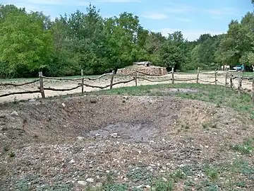 Fosse avec reliquat de combustion