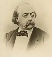 portrait en buste, très connu, noir et blanc, avec moustache et gros nœud-papillon