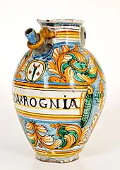 Verseuse à décor de spirales de feuilles échancrées, au-dessus l'emblème du cartouche médicinal de la béquille de l' hôpital Santa Maria Nuova, Montelupo Fiorentino, première moitié XVIIe&nbsp;siècle.