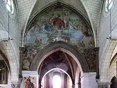 Photographie en couleurs d'une fresque représentant une scène religieuse peinte sur un arc architectural.