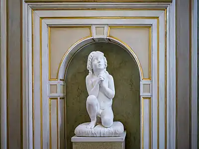 Kneeling child at prayer in the Palazzo Tosio, Brescia