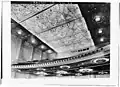 1932 image of auditorium ceiling and balcony soffit. Round holes in balcony edge are for stage lighting instruments. Dark windows in far wall are for film projectors and spotlights.[Traduire&nbsp;passage]
