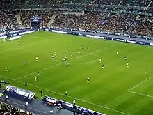 Les joueurs de l'US Quevilly et de l'Olympique lyonnais évoluant sur la pelouse du Stade de France lors de la finale de la Coupe de France 2012.