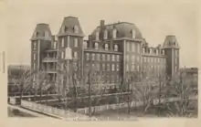 Photographie noir et blanc de l'immeuble d'une institution scolaire.