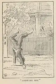 Dans la rue, garçon marchant sur les mains, depuis son jardin, une fillette le regarde.