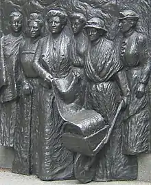 Sculpture en bas-relief en bronze représentant plusieurs femmes.