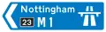 Panneau directionnel indiquant une ville desservie par une autoroute