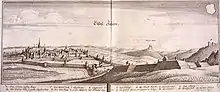gravure ancienne représentant une ville médiévale entourée de remparts avec un paysage de montagnes à l’arrière plan