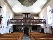 Vue intérieure de la nef vers la tribune de l'orgue Stiehr (1859).