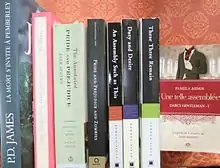 Une étagère sur laquelle se trouve une dizaine de romans.